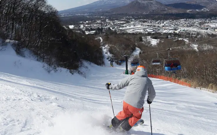 Snowboarders enjoying the slopes at Karuizawa Prince Hotel Ski Resort.